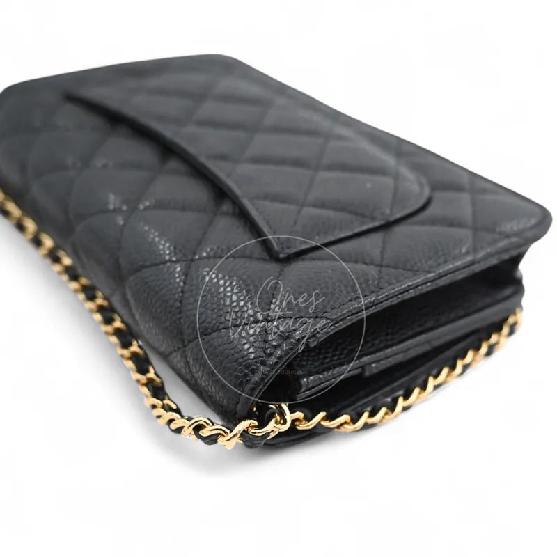 Chanel Wallet on Chain in black quilted caviar leather with gold hardware, Series 22, left side gusset and chain attachment