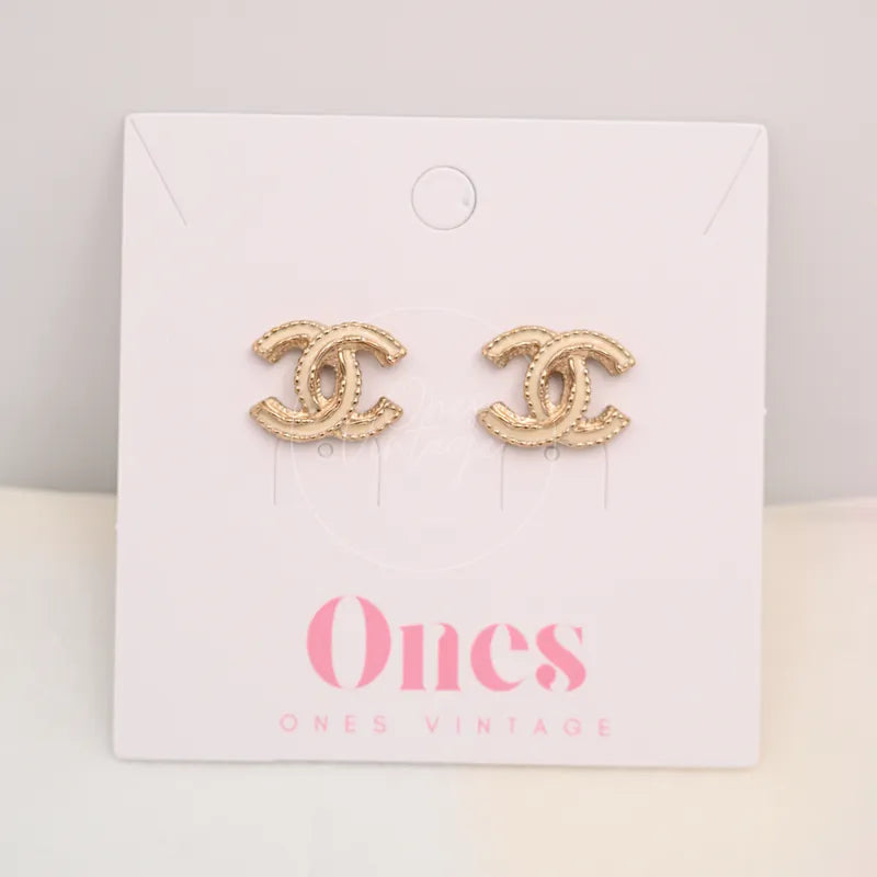 Chanel CC Logo Gold Plated Metal Earrings in gold-plated metal, featuring interlocking CC logo earrings and textured gold-tone finish, front view