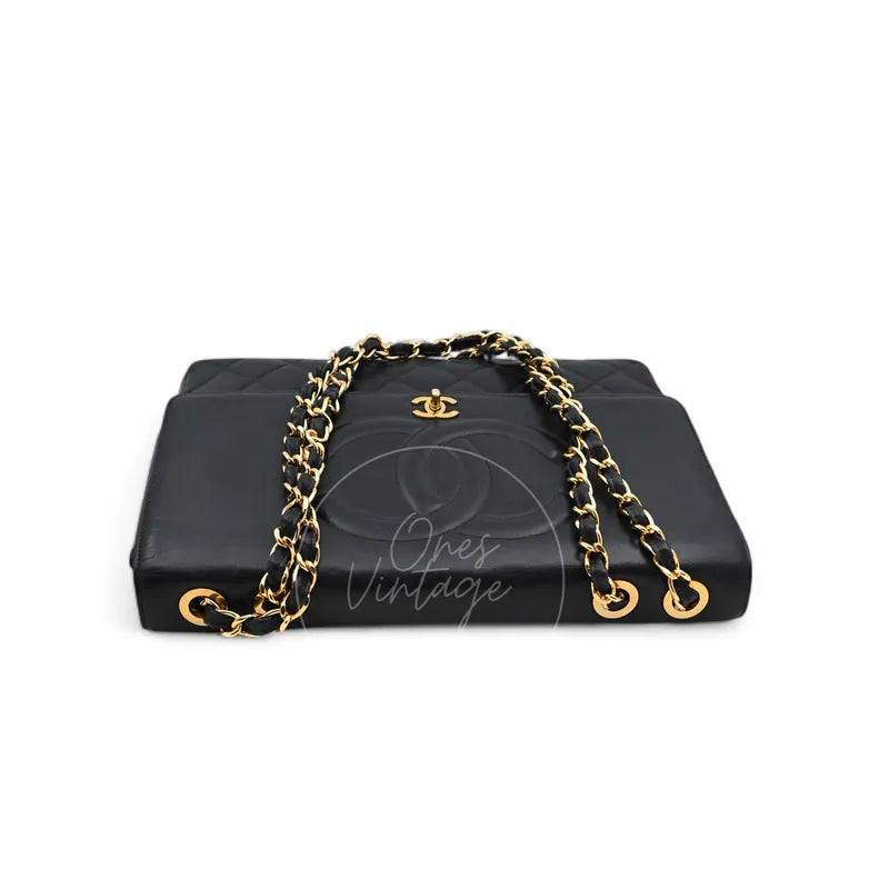 Chanel Vintage Maxi CC Straight Flap Bag in black lambskin, featuring interwoven chain strap and CC turn-lock clasp, front view