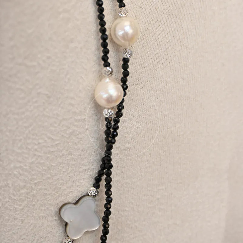 Akoya Necklace With, clover-shaped light pendant and black beaded chain detail