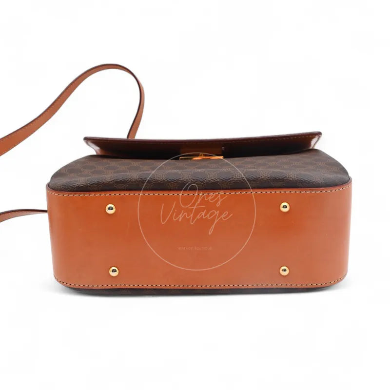 Celine Vintage Macadam Turn Lock Handbag in brown pvc, featuring four protective feet with attached shoulder strap, base view