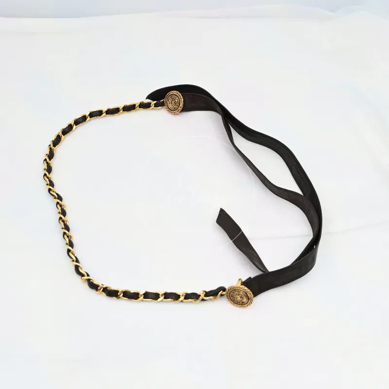 Chanel Chain Belt in black and gold, featuring interwoven chain strap and black leather sections, front view