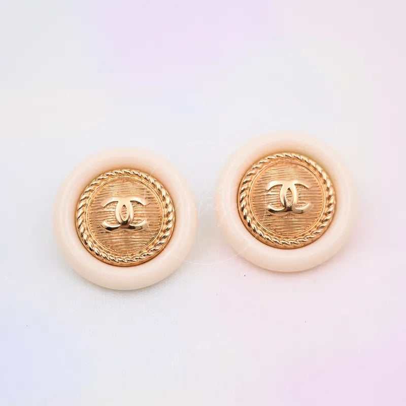 Chanel White Button With Gold CC Mark Stud Earrings in gold-plated and resin, featuring paired round stud earrings and raised CC motifs, front view