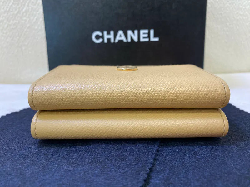 Chanel CC Logo Compact Trifold Wallet in beige calfskin, featuring snap closure and closed trifold silhouette, front view