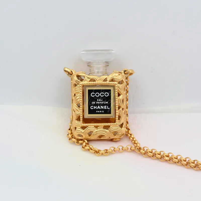 Chanel Perfume Bottle 18K Plated Necklace in 18K gold-plated and plastic, featuring perfume bottle-shaped pendant, front view