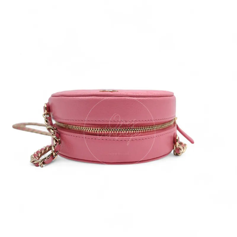 Chanel round clutch bag in pink camellia-embossed caviar leather with gold hardware, Series 29, top zipper view