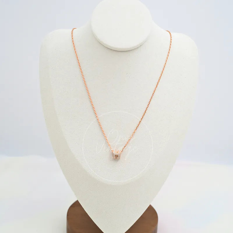 Hermès Mini Pop H Grey Pendant Necklace with Rose Gold in gold-plated alloy metal, featuring fine chain and small geometric pendant, front view