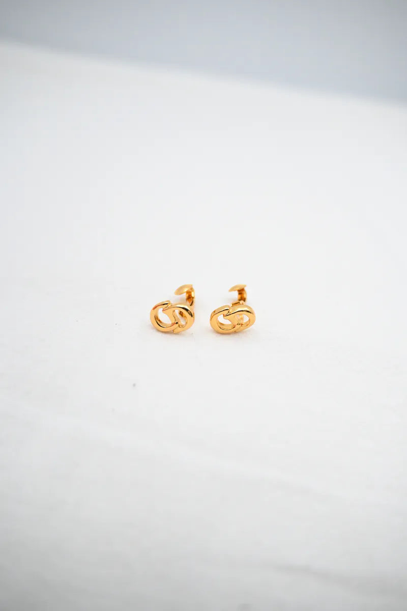 Dior CD Logo Earrings in gold plate, featuring interlocking curved motifs and paired logo earrings, front view
