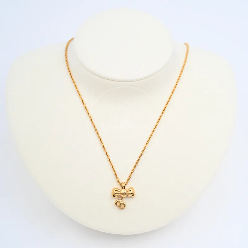 Dior Vintage Ribbon Necklace in alloy metal, featuring bow-shaped pendant and curled lower loop, front view