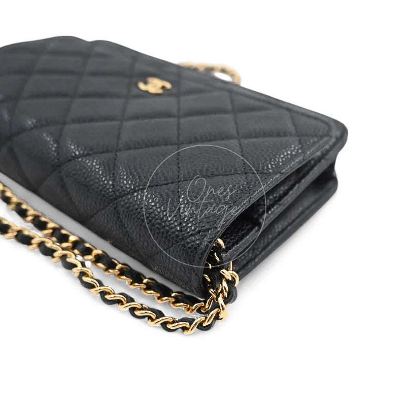Chanel Wallet on Chain in black quilted caviar leather with gold hardware, Series 22, front left corner