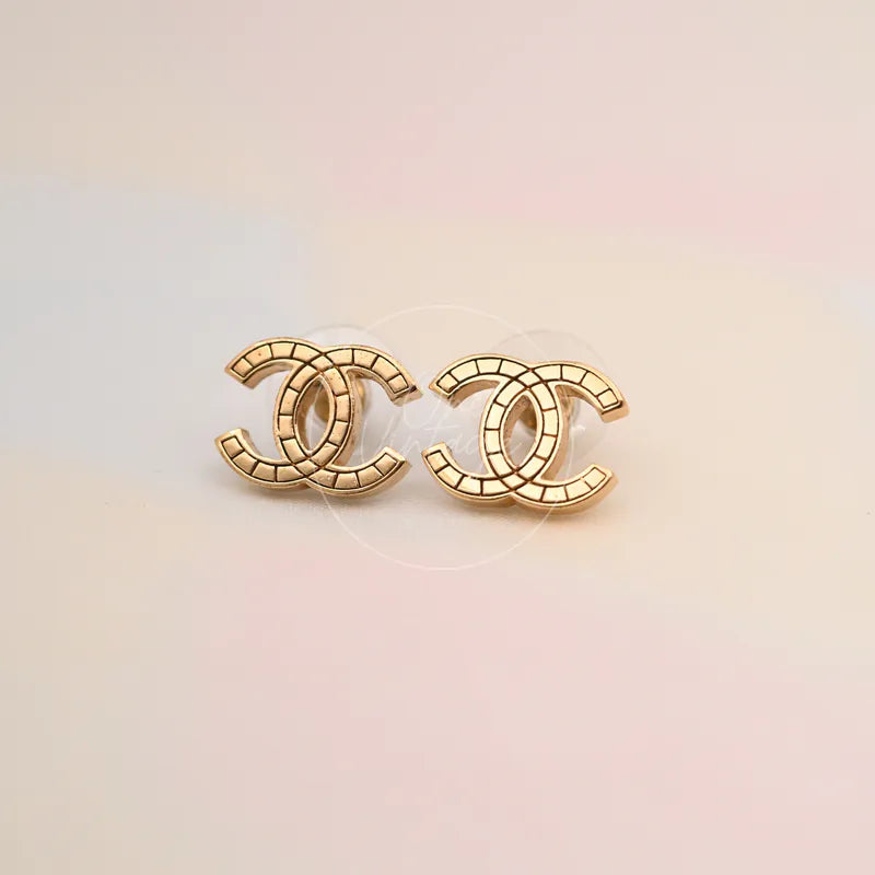 Chanel Film Pattern CC Mark Stud Earrings in gold-plated, featuring matching interlocking CC motifs and film-pattern engraving, front view