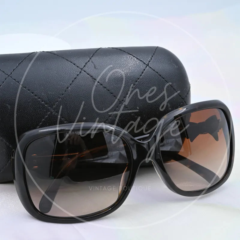 Chanel Sunglasses in black tortoiseshell, featuring oversized rounded-square frames and gradient tinted lenses, front three-quarter view
