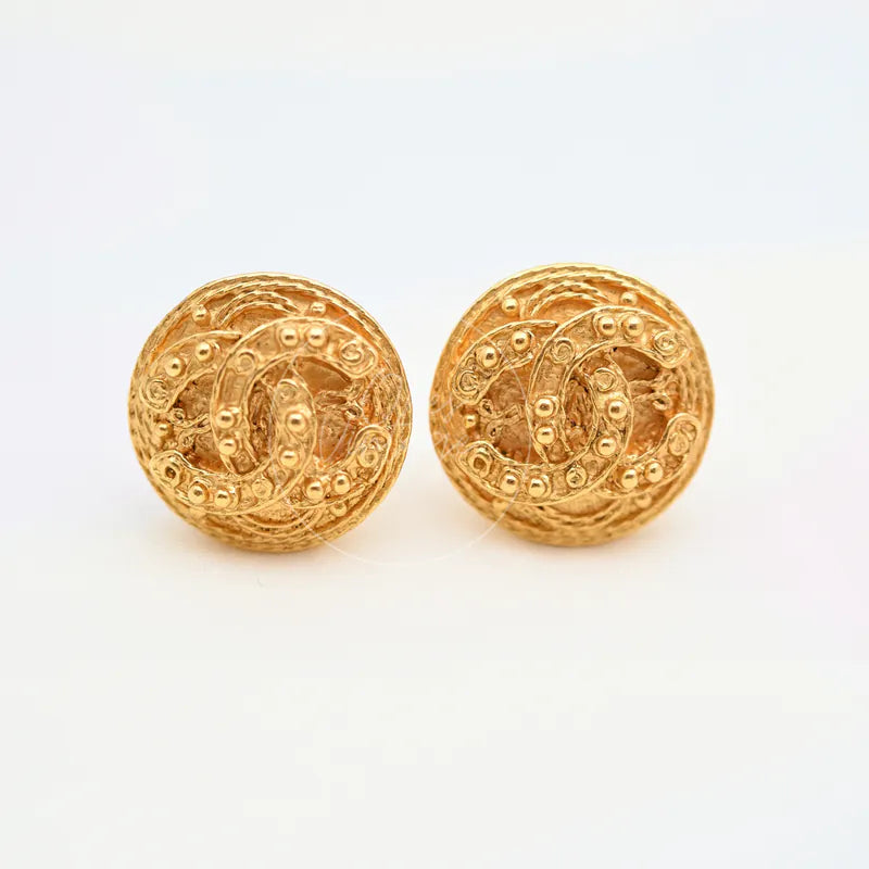 Chanel Vintage CC Filigree Round Clip-On Earrings in gold-plated, featuring round embossed interlocking CC motif, front view