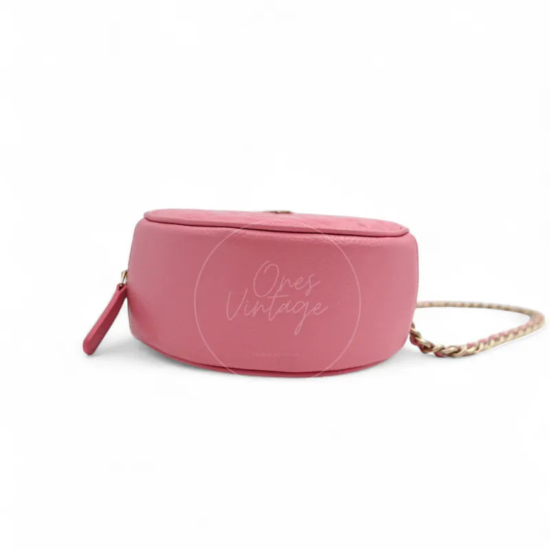 Chanel round clutch bag in pink camellia-embossed caviar leather with gold hardware, Series 29, smooth base view