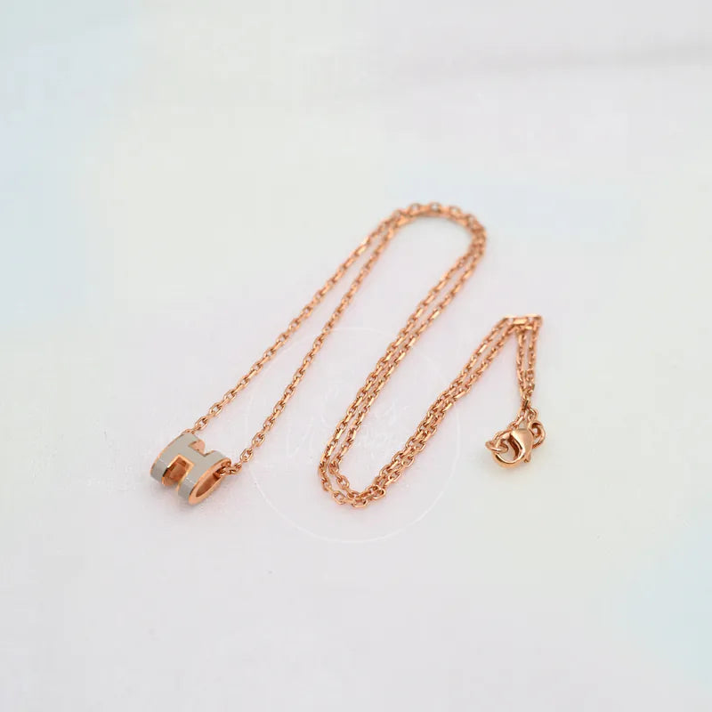 Hermès Grey Rose Gold Mini Pop H Necklace in alloy metal, featuring lobster clasp and geometric pendant, front view