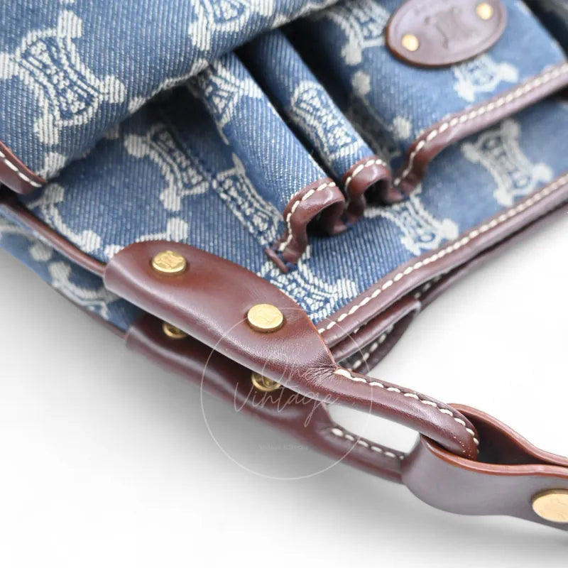 Close-up of brown leather strap attachment and gold Triomphe rivets on vintage Céline denim bag