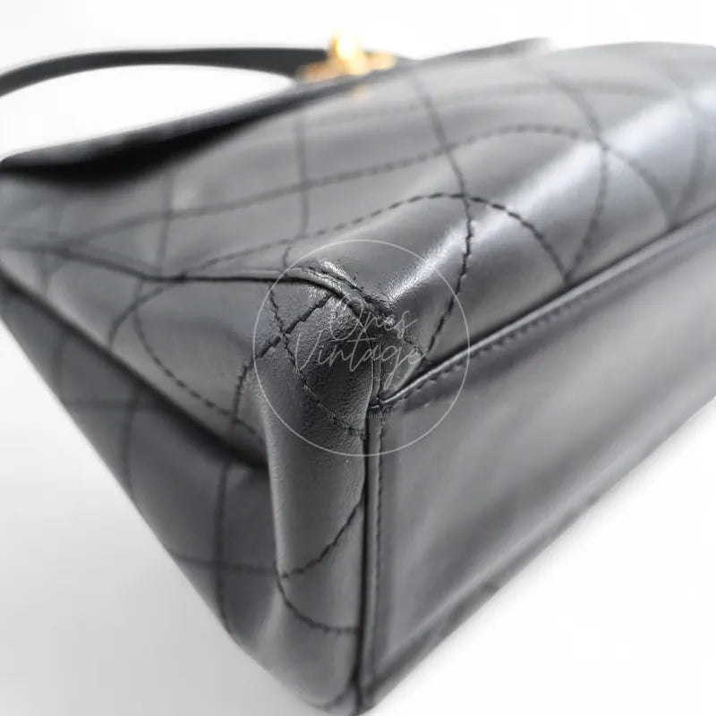 Chanel vintage turn-lock shoulder bag in black quilted lambskin with gold hardware, Series 5, rear left base corner