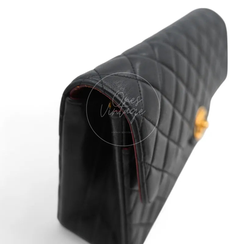 Side view of Chanel vintage flap bag showing lambskin leather quilting and side profile