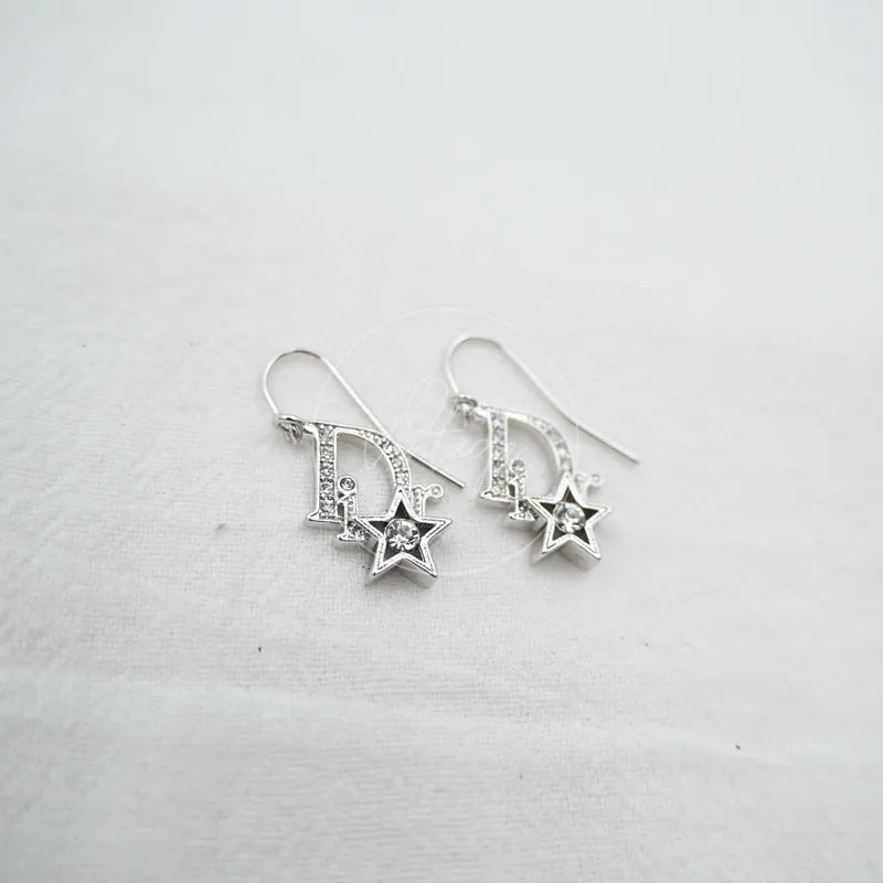 Dior Sliver Star Logo Drop Earrings in sterling silver, featuring D logo drop design and star-shaped pendant detail, front view