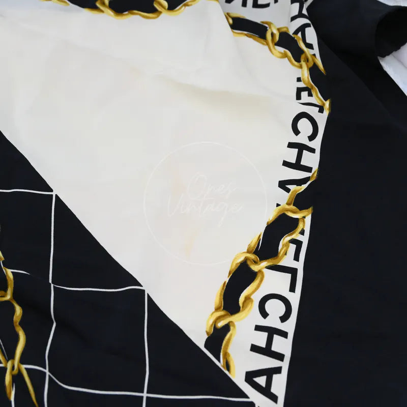 Chanel and Scarf, logo with gold chain motif and black-and-white geometric pattern detail