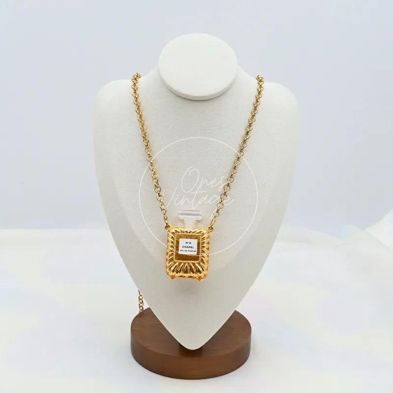 Chanel Vintage N19 Perfume Bottle Necklace in 18K gold-plated metal and plastic, featuring rectangular perfume-bottle pendant, front view
