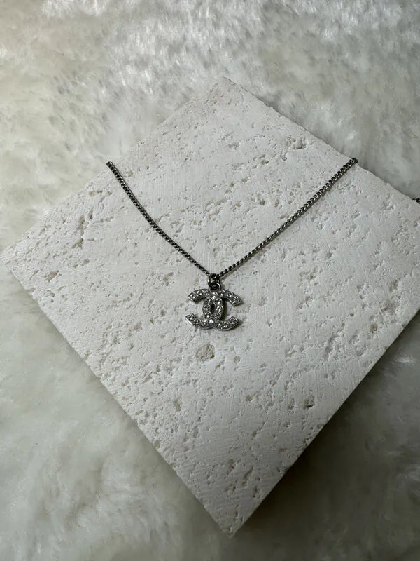 Chanel CC Mark Necklace in metal and crystal, featuring interlocking CC pendant and pavé stone accents, front view
