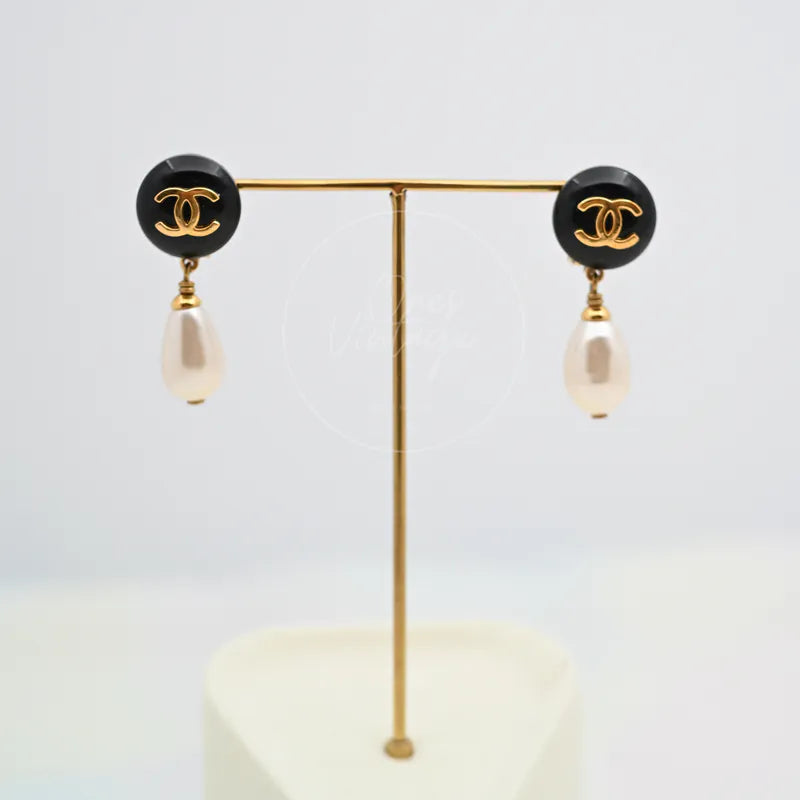 Chanel Teardrop Pearl CC Dangle Earrings in gold-plated, plastic and artificial pearl, featuring paired black circular CC motifs, front view