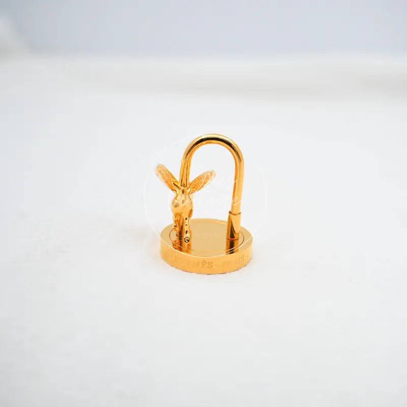Hermès Pegasus Cadena Charm in gold, featuring Pegasus motif and circular base, front three-quarter view