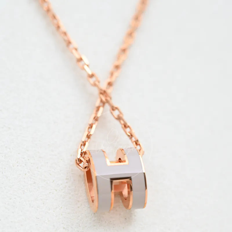 Hermès Mini Pop H Grey Pendant Necklace with Rose Gold, grey-and-rose-gold curved pendant and double-loop pendant form detail