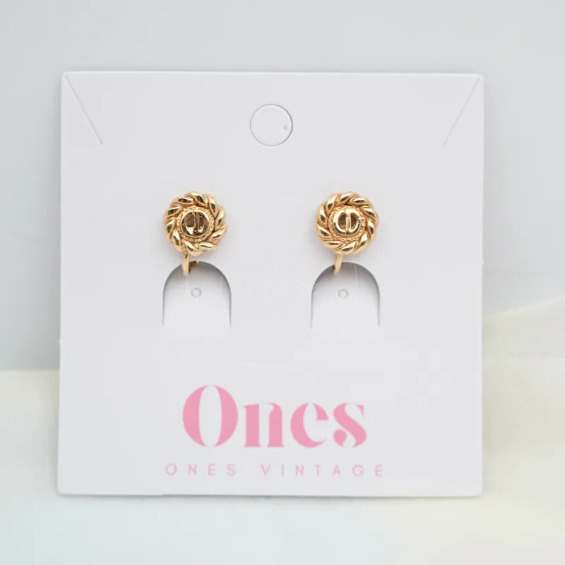 Dior Metal Swirl Earclips watch in alloy metal, featuring circular swirl earclips and matching pair, front view