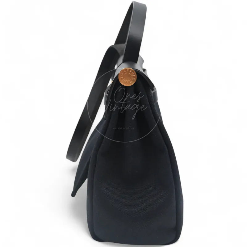 Hermès Herbag Zip 31 Canvas, featuring structured gusseted side profile and top handle and extended strap, right side view
