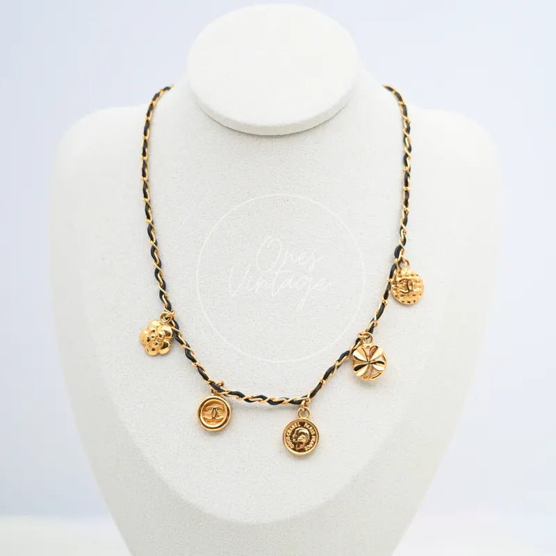 Chanel Vintage Medallions Gold Necklace in gold-plated metal and leather, featuring floral charm and twisted black-and-gold chain, front view