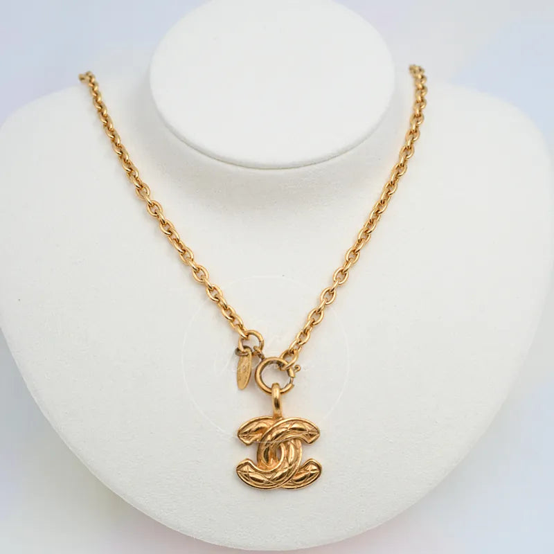 Chanel Matelasse Coco Mark Pendant Necklace in gold-plated metal, featuring interlocking CC pendant and linked chain, front view