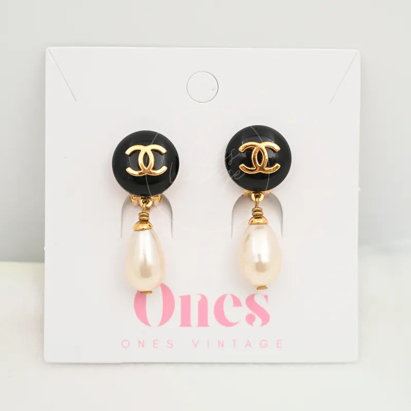 Chanel Teardrop Pearl CC Dangle Earrings in gold-plated, plastic and artificial pearl, featuring black round CC medallion tops, front view