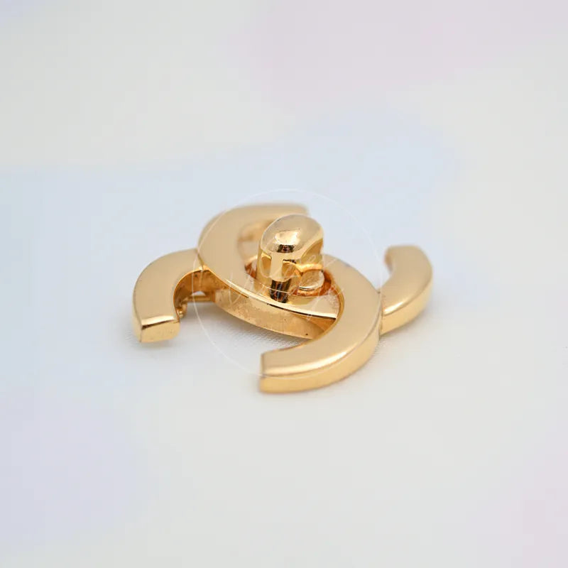 Chanel Vintage CC Logo 24K Plated Brooch in 24K gold-plated, featuring central rotating clasp and horizontal pin closure, back view