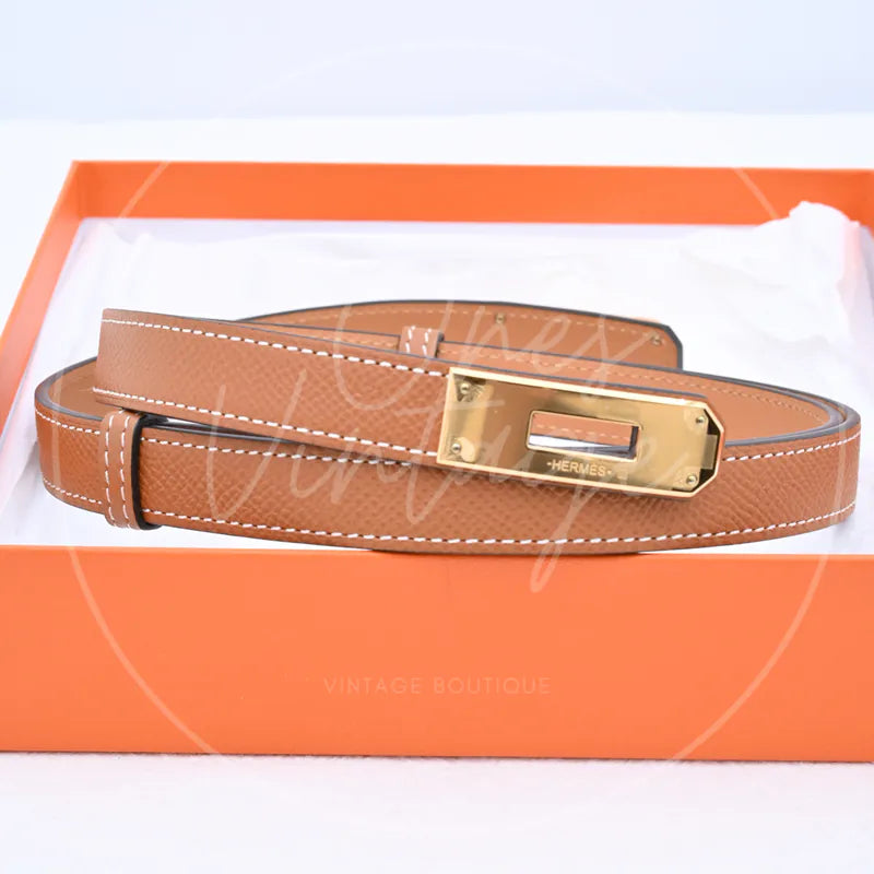 Hermès Kelly Belt in gold epsom leather with gold-tone hardware, featuring rectangular metal buckle with presentation box, front view
