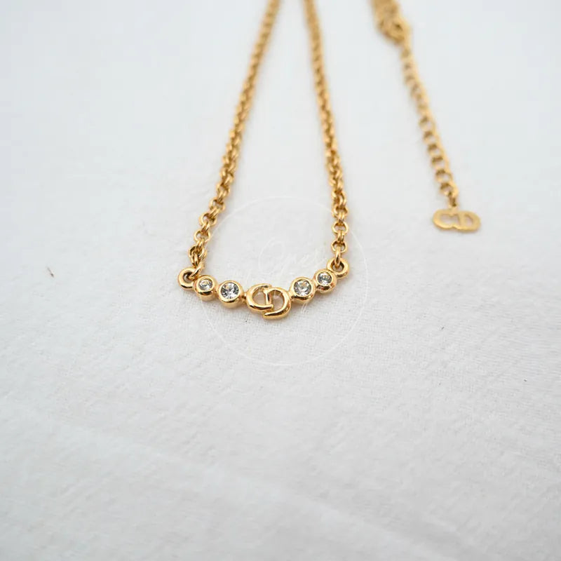 Dior CD Logo Necklace in alloy metal and rhinestone, featuring circular stone accents and linked chain, front view