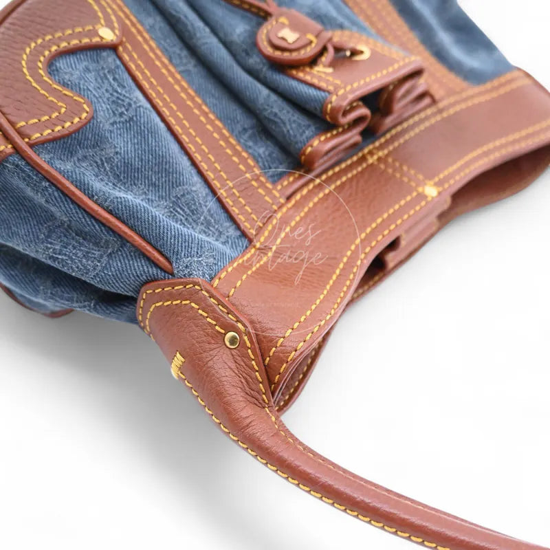 Top view of Céline vintage denim bag showing brown leather strap and contrast stitching
