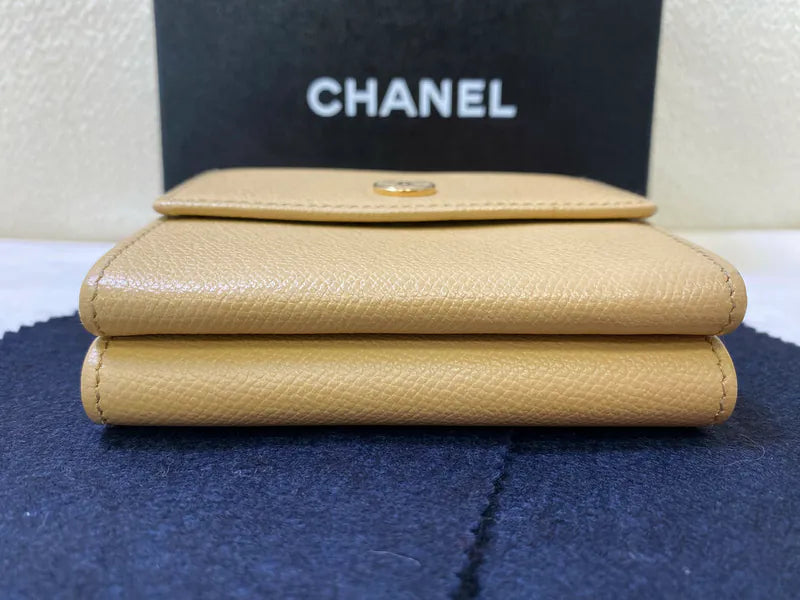 Chanel CC Logo Compact Trifold Wallet in beige calfskin, featuring snap closure and pebbled leather texture, front view