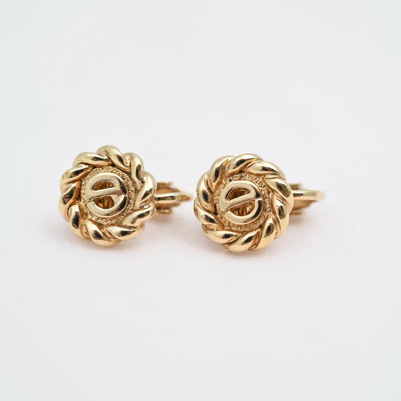 Dior Metal Swirl Earclips watch in alloy metal, featuring paired round earclips and braided relief border, front view