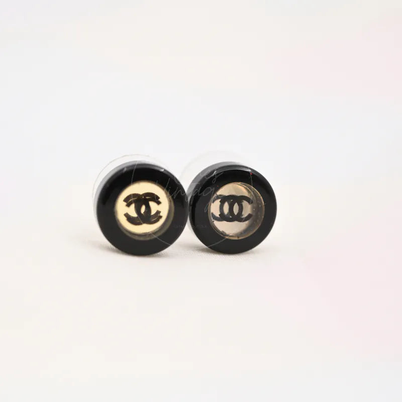 Chanel CC Mark Logo Black Button Stud Earrings in resin and metal, featuring interlocking CC logo centers and pair of round stud earrings, front view