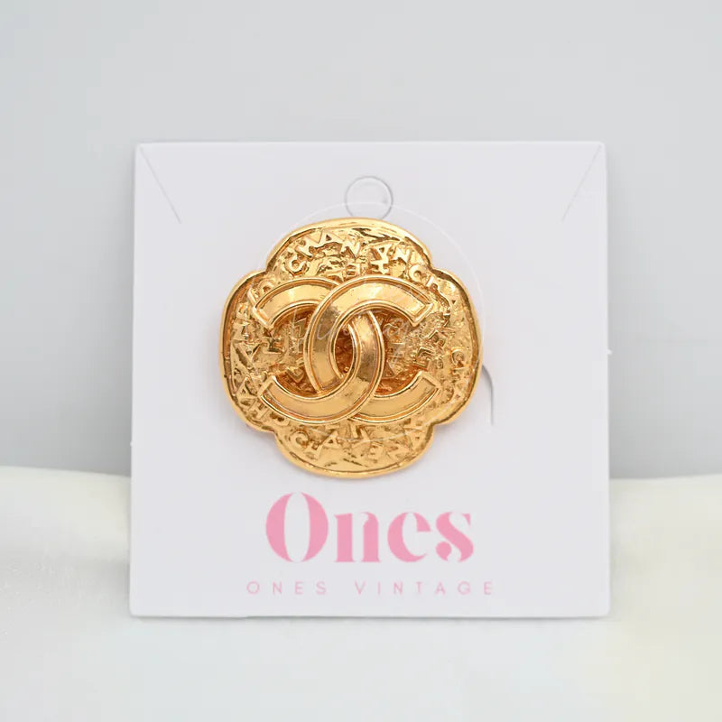 Chanel GP Coco Mark 24K Brooch in 24K gold, featuring scalloped floral outline and interlocking CC motif, front view