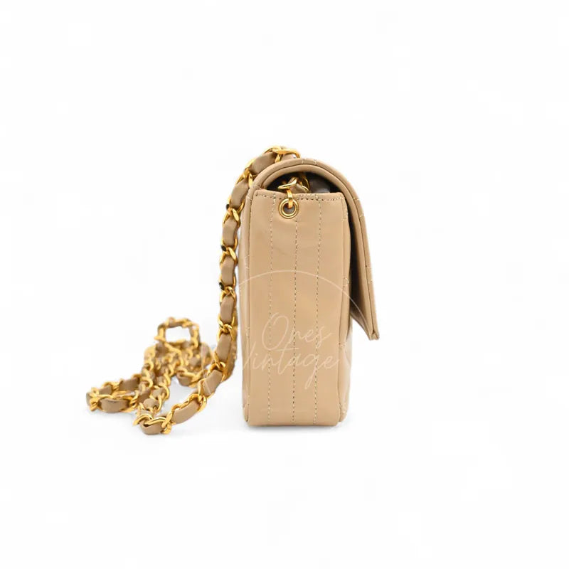 Chanel Vintage Single Flap bag with big CC in beige lambskin with gold-tone hardware, featuring flap edge with chain shoulder strap, left side view