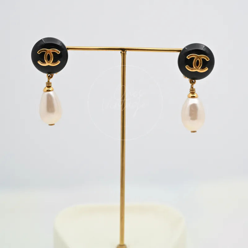 Chanel Teardrop Pearl CC Dangle Earrings in gold-plated, plastic and artificial pearl, featuring black circular CC motifs, front view