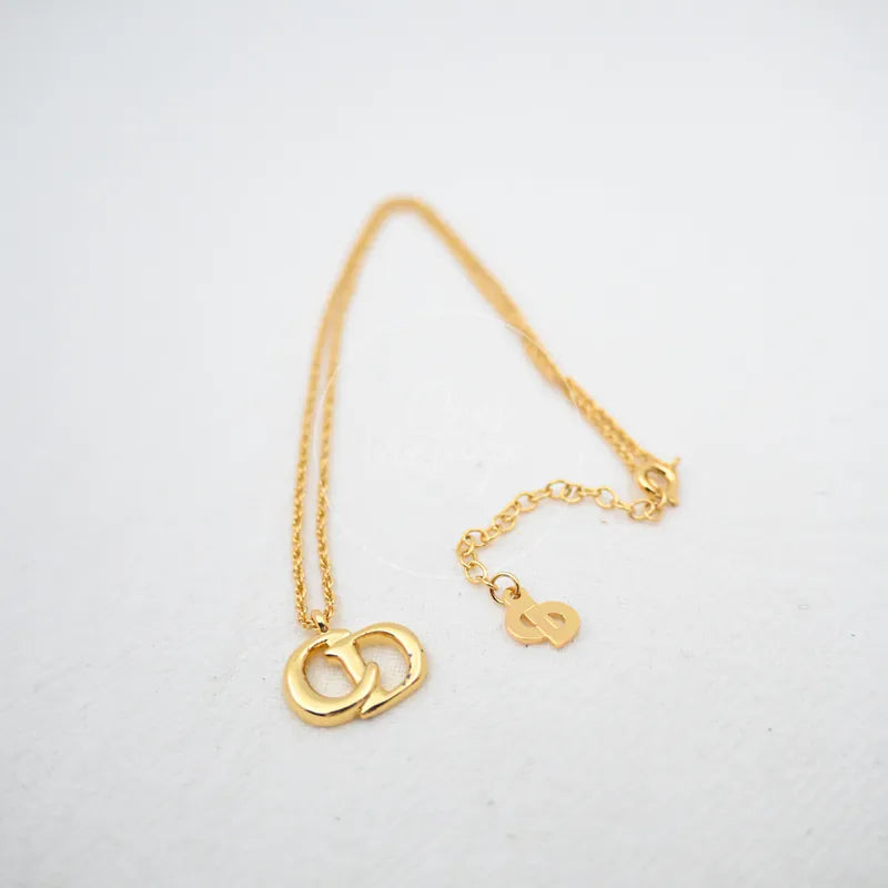 Dior CD Logo Necklace in plated gold, featuring double CD logo pendant and fine link chain, front view