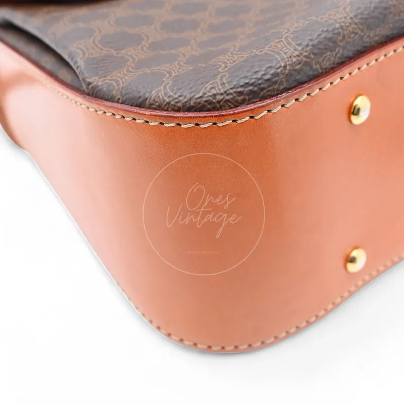 Bottom view of vintage Céline bag showing brown leather base corner and gold-tone protective studs
