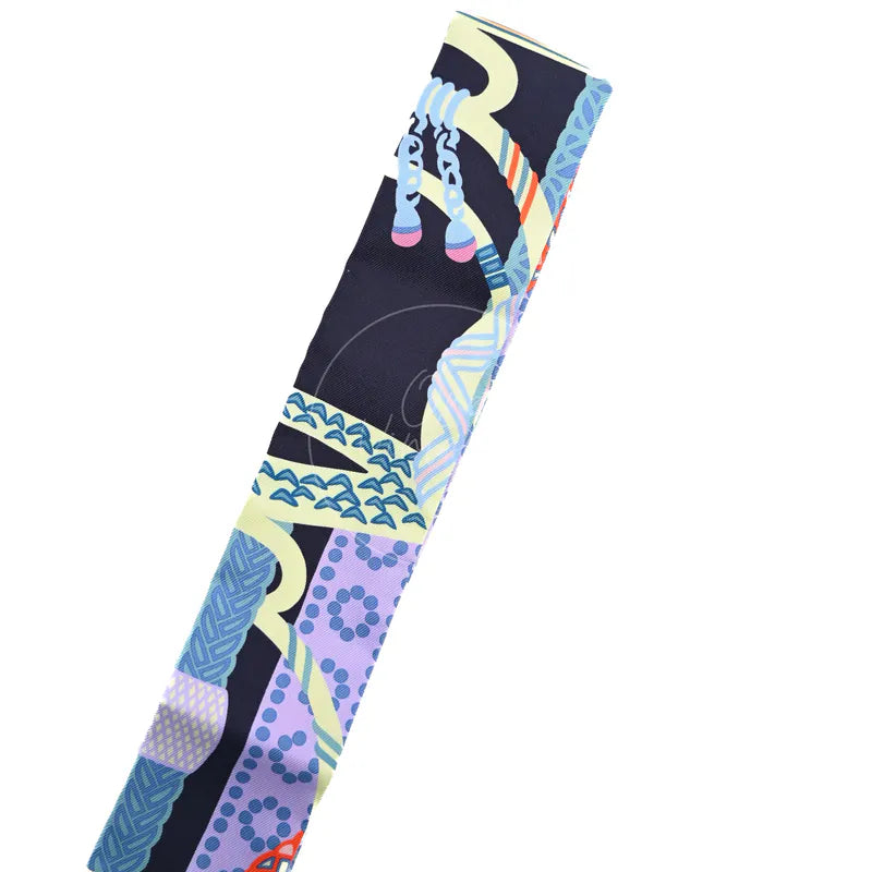 Hermès Fantaisie d'Etriers Twilly in marine, mauve and jaune soufre silk 100%, featuring equestrian-inspired printed motifs, front view