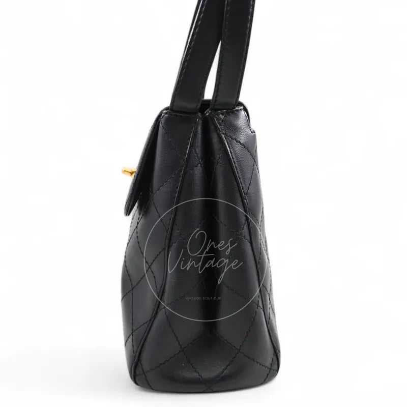 Chanel vintage turn-lock shoulder bag in black quilted lambskin with gold hardware, Series 5, left side profile