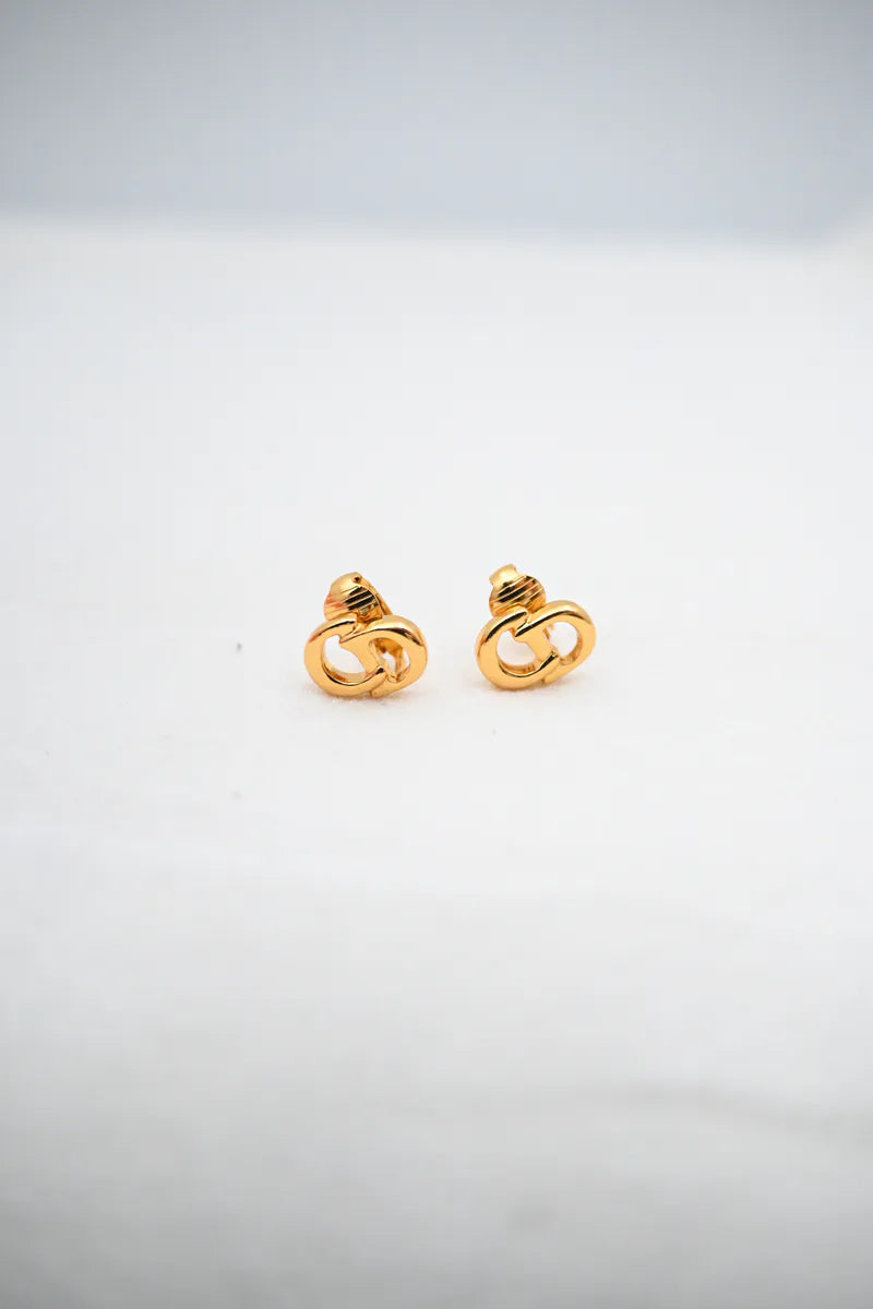 Dior CD Logo Earrings in gold plate, featuring paired interlocking logo forms and circular openwork design, front view