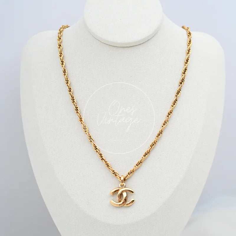 Chanel CC Pendant Necklace in gold-plated, featuring interlocking CC pendant and twisted chain, front view